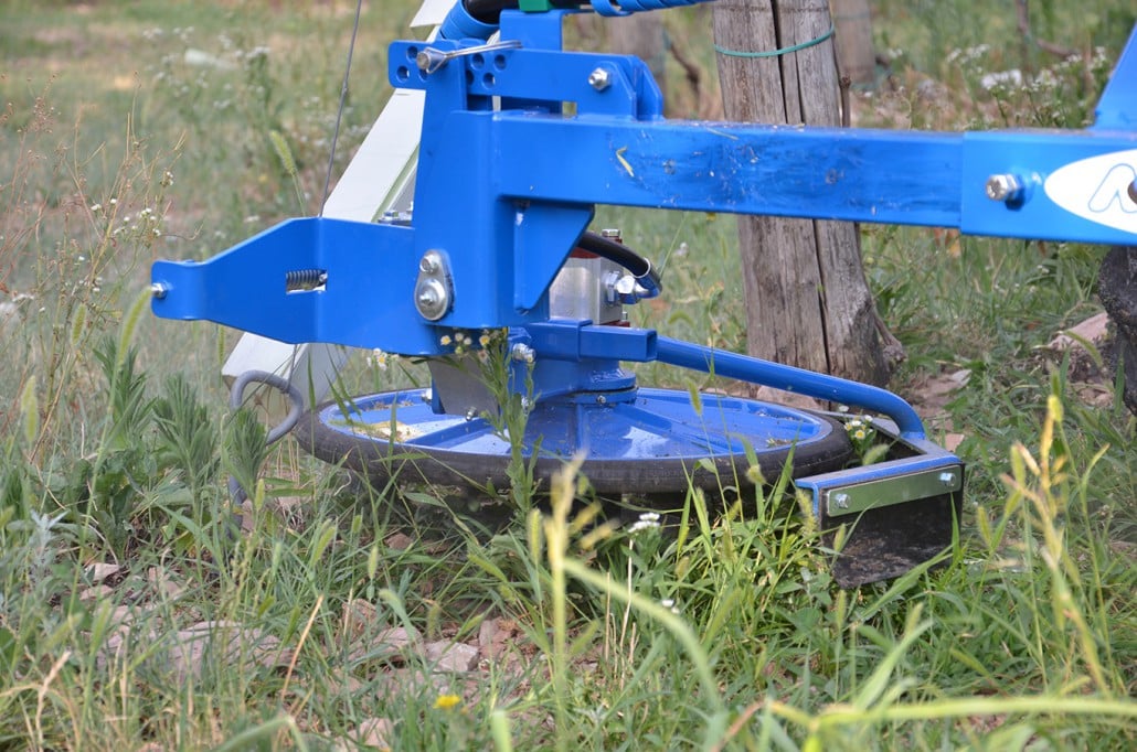 detail of an inter row mower on grass