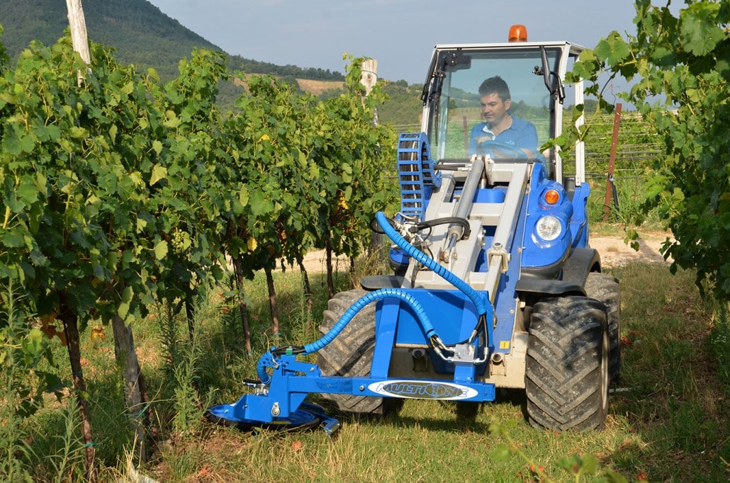 inter row mower in action in a vineyard