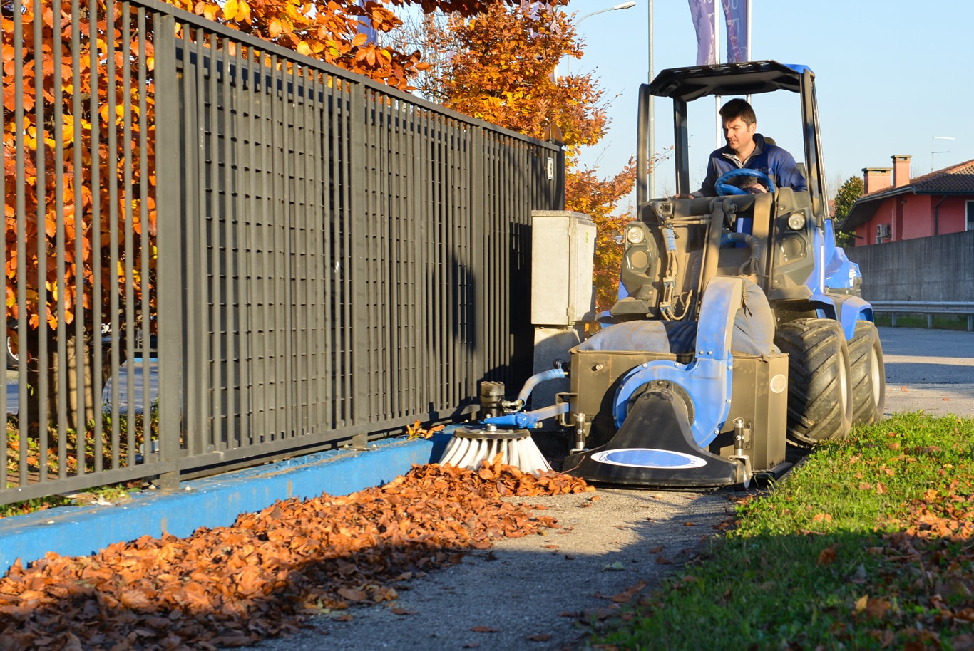 leaf vacuum cleaning a side street from leaves
