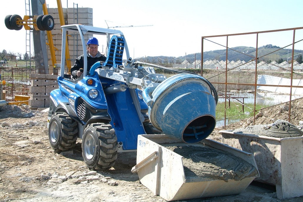 man using a cement mixer and putting the result in a bucket