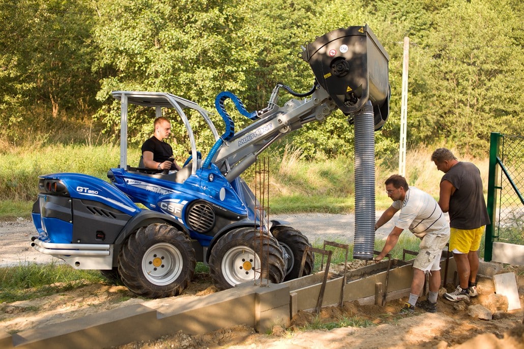 two men working with a concrete mixing bucket
