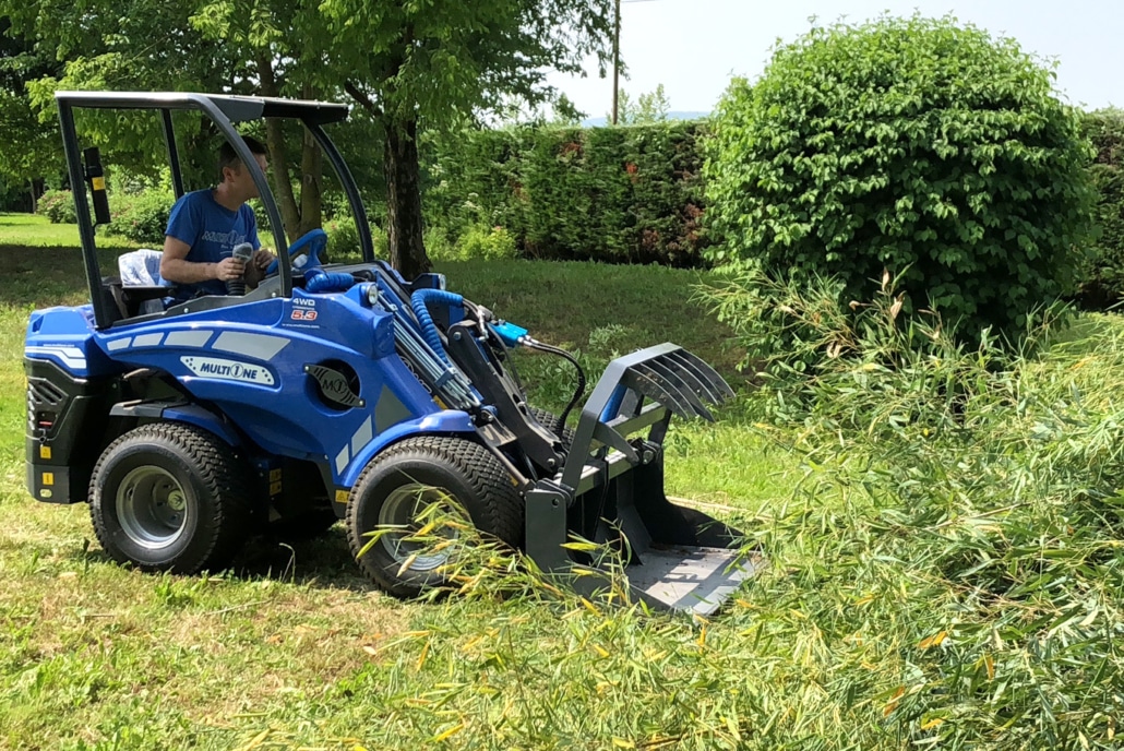 grapple bucket working in a garden