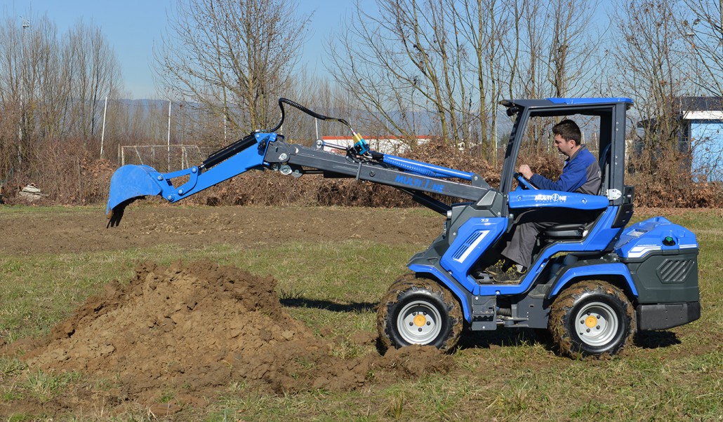 mini digger releasing soil