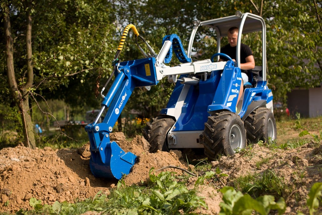 mini digger working on soil