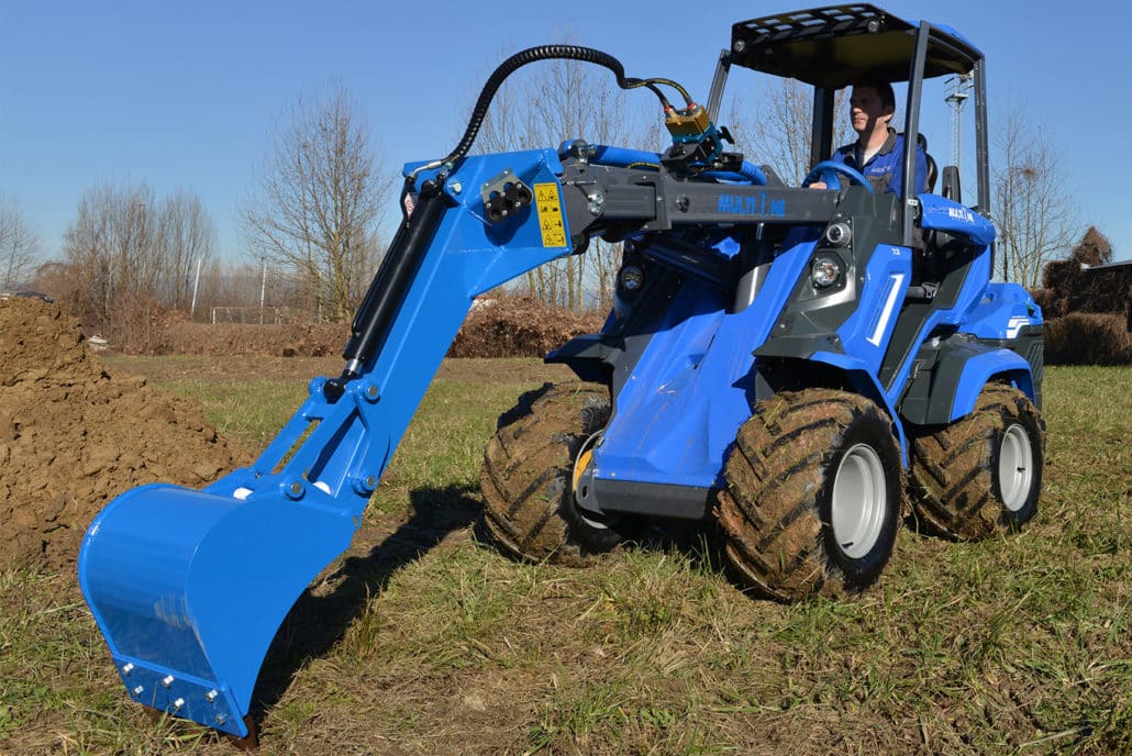 mini digger in a field,front view