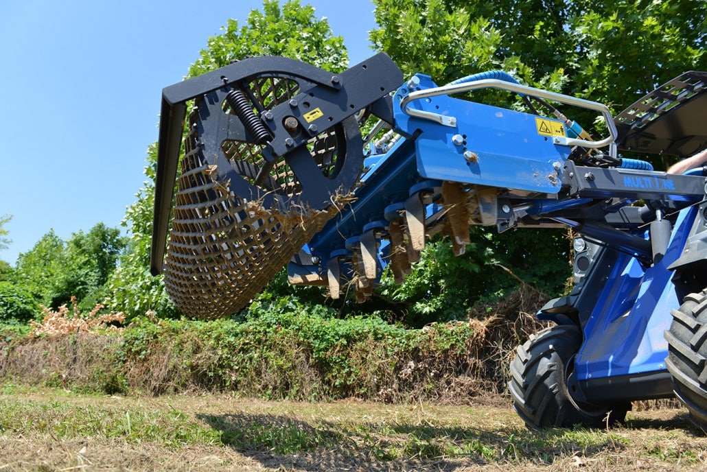 power harrow working on soil, view from below