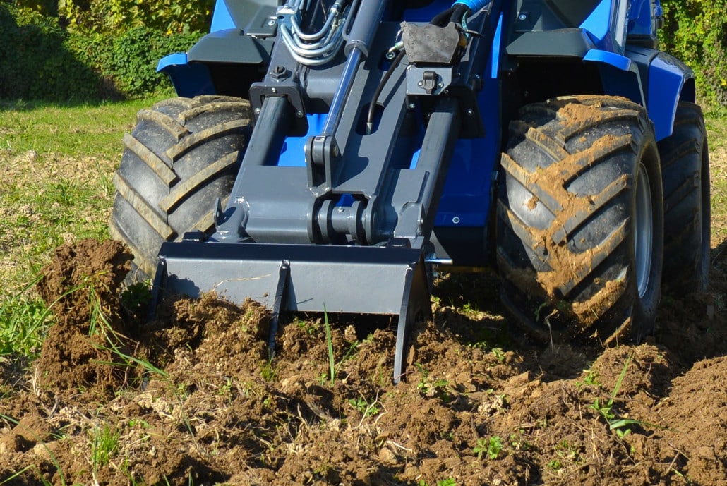 detail of the front of a ripper moving soil
