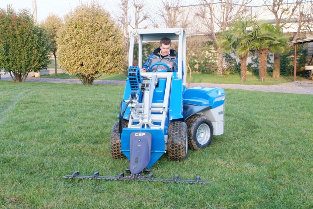sickle bar mower in action on a lawn