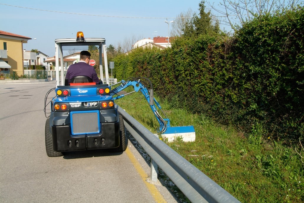 side boom with flail mower DZ2 cutting grass on the street side
