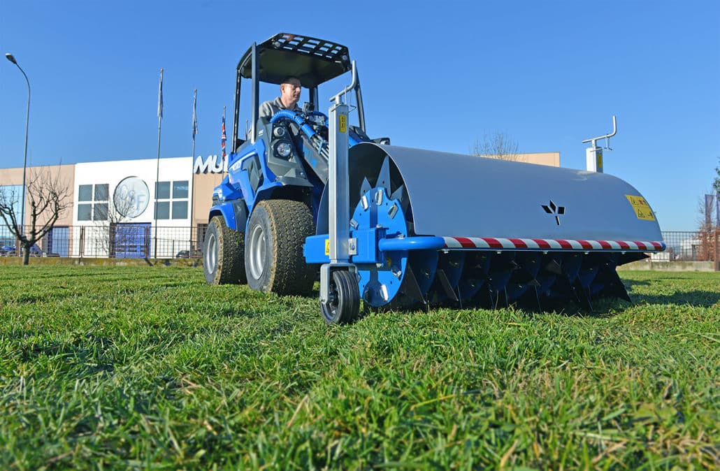 spike aerator on a grass field seen from below