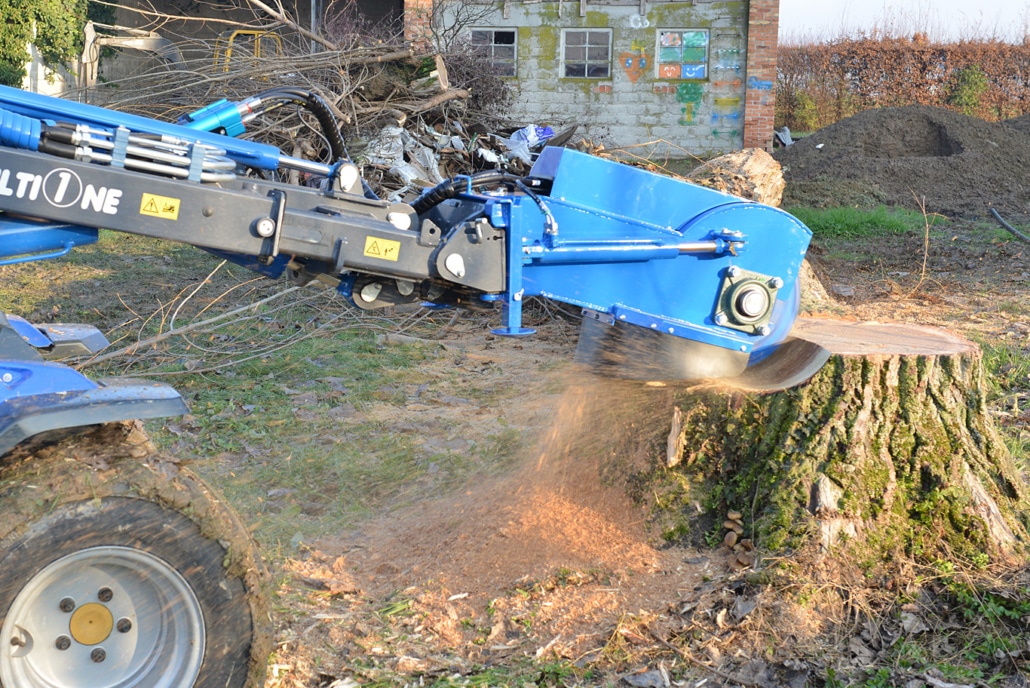 swing stump grinder grinding on a stump