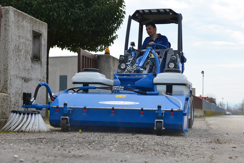 sweeper with collector on the right side cleaning a street